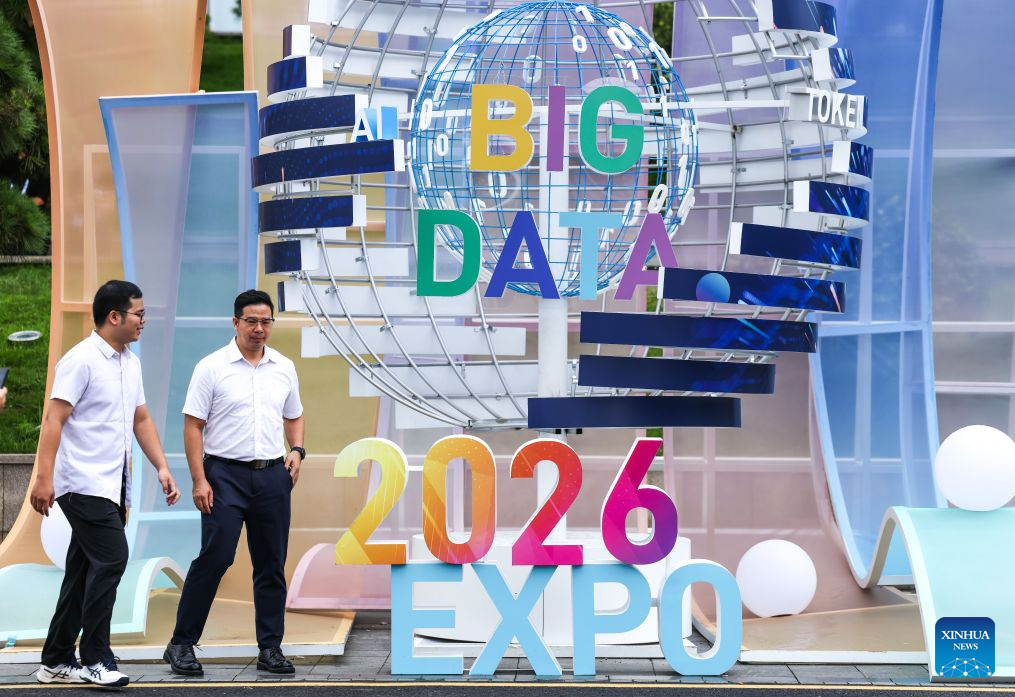 People walk past a logo of the 2026 China International Big Data Industry Expo in Guiyang, southwest China's Guizhou Province, Aug. 28, 2026. The 2026 China International Big Data Industry Expo opened on Friday.  Themed "Token: A New Path to Value of Data Elements," the expo has attracted 372 domestic and international companies and over 16,000 registered guests. (Xinhua/Yang Wenbin)