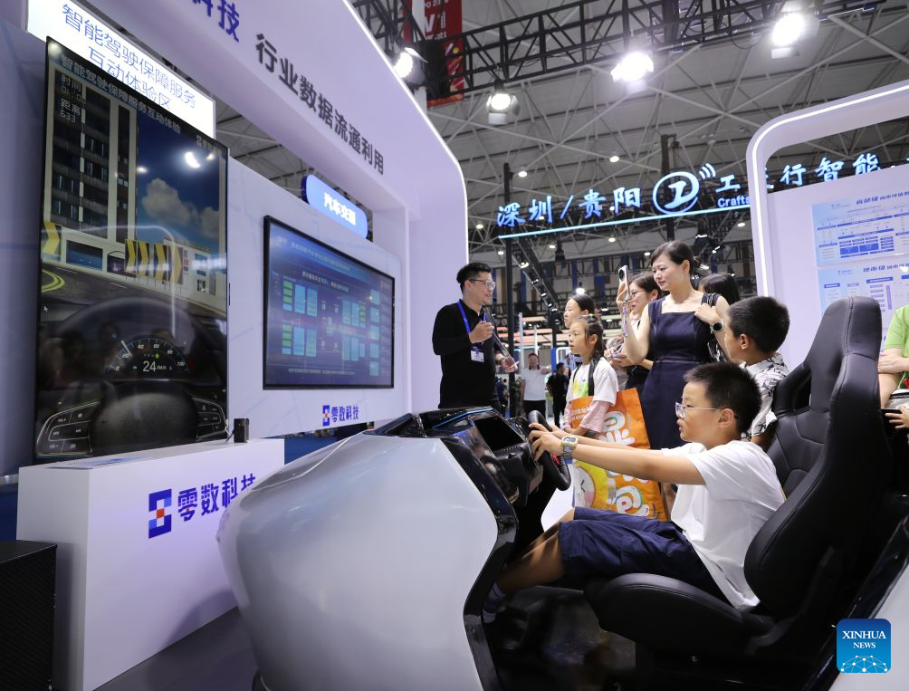 Children experience smart mobility technology during the professional exhibition of the 2026 China International Big Data Industry Expo in Guiyang, southwest China's Guizhou Province, Aug. 28, 2026. Themed "Token: A New Path to Value of Data Elements," the expo spotlights cutting-edge innovations integrating data with artificial intelligence. (Xinhua/Li Xulun)