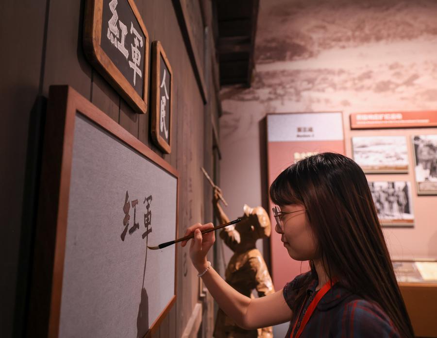 A woman visits a themed exhibition commemorating the 90th anniversary of the victory of the Long March at the Military Museum of the Chinese People's Revolution during a media preview in Beijing, capital of China, Sept. 21, 2026.  (Xinhua/Yin Gang)