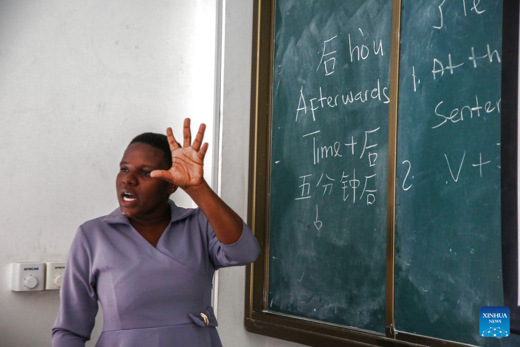 Tanzanian Chinese language teacher Gloria Mshana explains Chinese grammar to students in front of the blackboard at the Confucius Institute at the University of Dar es Salaam in Dar es Salaam, Tanzania, Oct. 1, 2026. As the world prepares to mark World Teachers' Day on Oct. 5, Chinese and Tanzanian educators are joining forces to expand Chinese language education in Tanzania, blending native linguistic expertise with localized cultural insights. (Xinhua/Emmanuel Herman)
