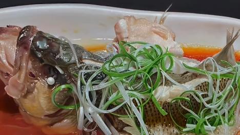 Hyper-realistic painting: A braised fish that looks freshly cooked