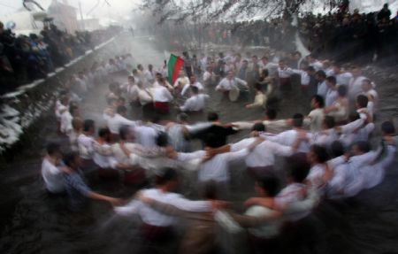 Bulgarians dance together in icy water to mark Epiphany Day