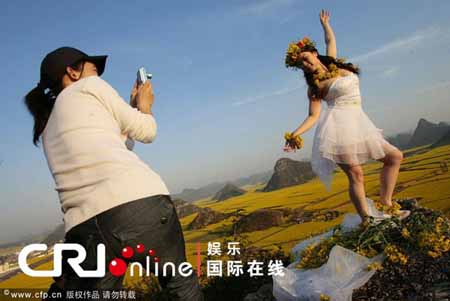 Sister Furong poses in blooming rapeseed fields 
