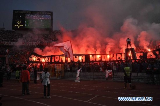 Fans light flares during match between Zamalek and Africain in Cairo