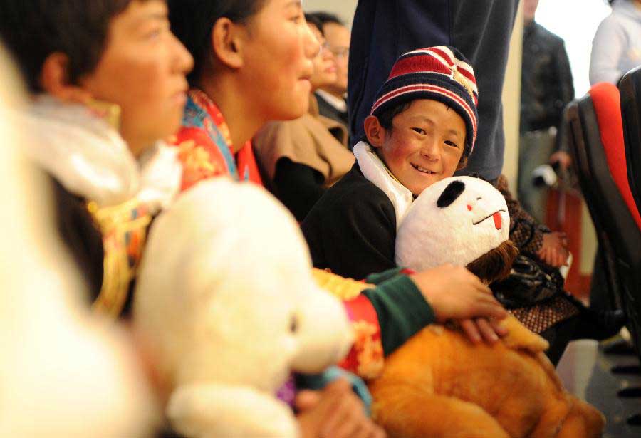 A boy of Tibet ethnic group who is diagnosed with congenital heart disease (CHD) holds a panda doll as he arrives in Hefei, capital of east China's Anhui Province, Nov. 5, 2012. A total of 22 CHD children from China's Tibet Autonomous Region were brought to Anhui for a free medical treatment on Monday. (Xinhua/Liu Junxi) 