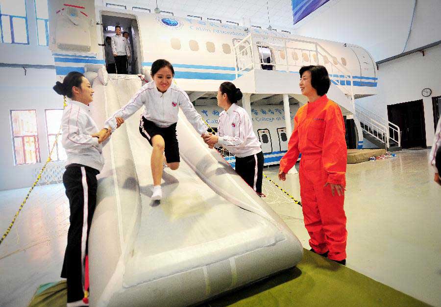 Students receive simulative training for Airbus A320 at the Cabin Attendant College of Civil Aviation University of China in north China's Tianjin, Nov. 2, 2012. (Xinhua/You Sixing)