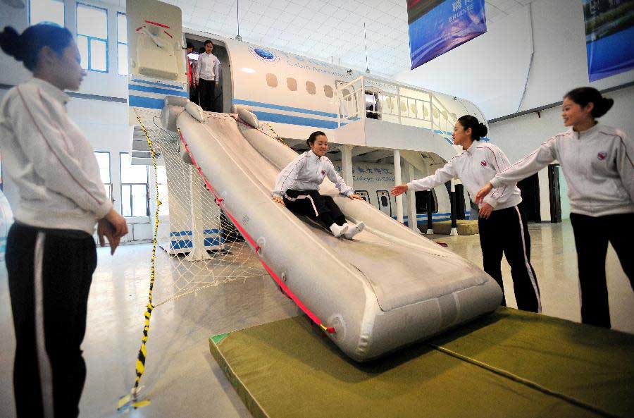 Students receive simulative training for Airbus A320 at the Cabin Attendant College of Civil Aviation University of China in north China's Tianjin, Nov. 2, 2012. (Xinhua/You Sixing)