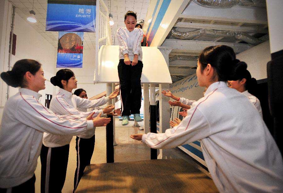 Students receive simulative training for Airbus A320 at the Cabin Attendant College of Civil Aviation University of China in north China's Tianjin, Nov. 2, 2012. (Xinhua/You Sixing)