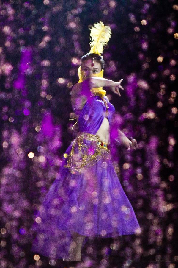 A dancer performs during a tourism dance "Tengchong Dream" in Tengchong County of southwest China's Yunnan Province, Nov. 4, 2012. The large-scale tourism dance is a national-standard grand cultural banquet which takes Tengchong's history and local customs as the main contents and can perfectly reflect the local features of Tengchong. (Xinhua/Zheng Huansong) 