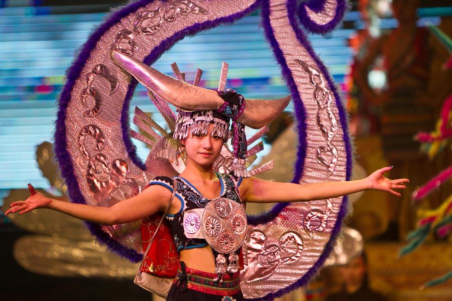 A dancer performs during a tourism dance "Tengchong Dream" in Tengchong County of southwest China's Yunnan Province, Nov. 4, 2012. The large-scale tourism dance is a national-standard grand cultural banquet which takes Tengchong's history and local customs as the main contents and can perfectly reflect the local features of Tengchong. (Xinhua/Zheng Huansong) 
