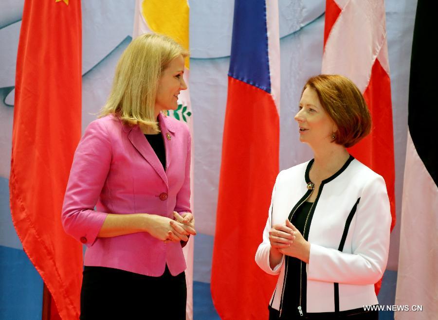 Australian Prime Minister Julia Gillard (R) talks with her Danish counterpart Helle Thorning-Schmidt before the opening ceremony of the Ninth Asia-Europe Meeting (ASEM) Summit in Laos, Vientiane, Nov. 5, 2012. Leaders from Asian and European opened the Ninth Asia-Europe Meeting (ASEM) Summit in Lao capital of Vientiane on Monday with economic and financial issues featuring high on the agenda. (Xinhua/Li Peng)