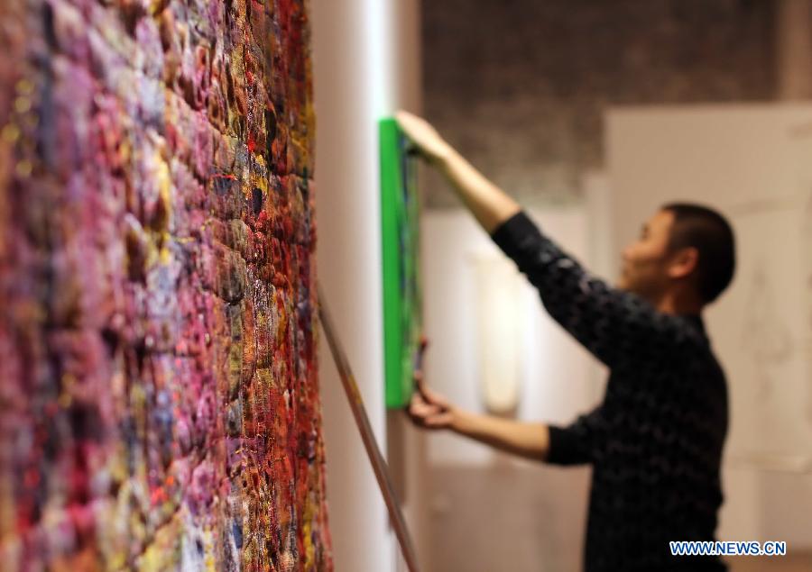 A staff member prepares for the 7th From Lausanne to Beijing FiberArt Biennial Exhibition in Nantong, east China's Jiangsu Province, Nov. 5, 2012. The exhibition, displaying more than 300 pieces of works from 37 countries and regions, will be held here from Nov. 8 to Dec. 5 this year. (Xinhua/Huang Zhe)