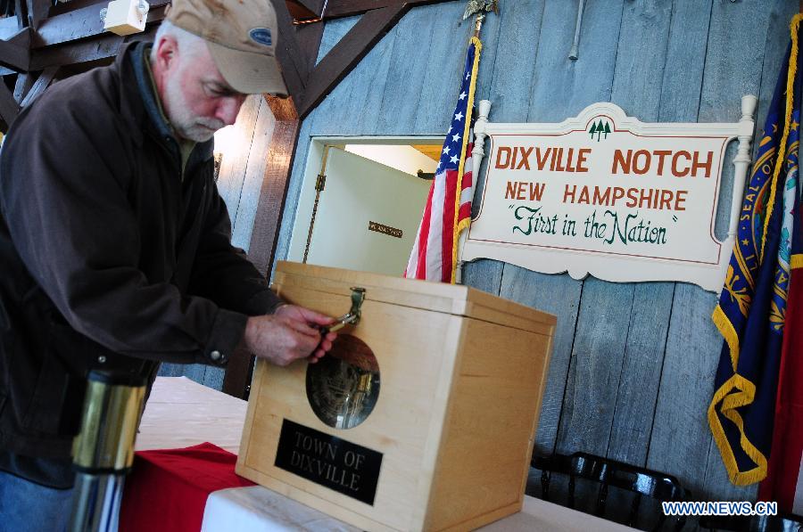 A working staff locks the ballot box during the preparation for the voting at a polling station in Dixville Notch, New Hampshire, the United States, Nov. 5, 2012. Ten registered voters are expected to cast their ballots at the stroke of midnight on Tuesday Nov. 6, in Dixville Notch, signifying the official beginning of the voting in the 2012 U.S. presidential elections. (Xinhua/Zhang Chuanshi) 