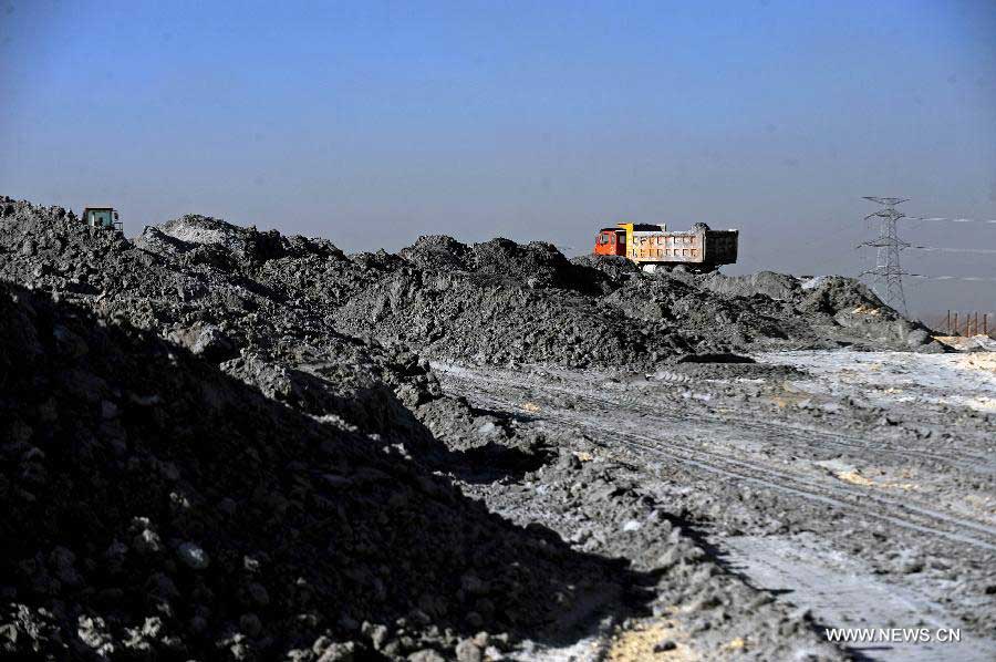 Trucks transport cinder in Shuozhou, north China's Shanxi Province, Oct. 31, 2012. As a city relying on coal power, Shuozhou has three major thermal power plants in its Shentou district. The thermal power plants emit some three million tons of coal ash each year. The pulverized fuel ash reclamation area, which used to be farmlands, is now covered with 120 million tons of coal ahses and becomes a huge pollution source. (Xinhua/Fan Minda) 