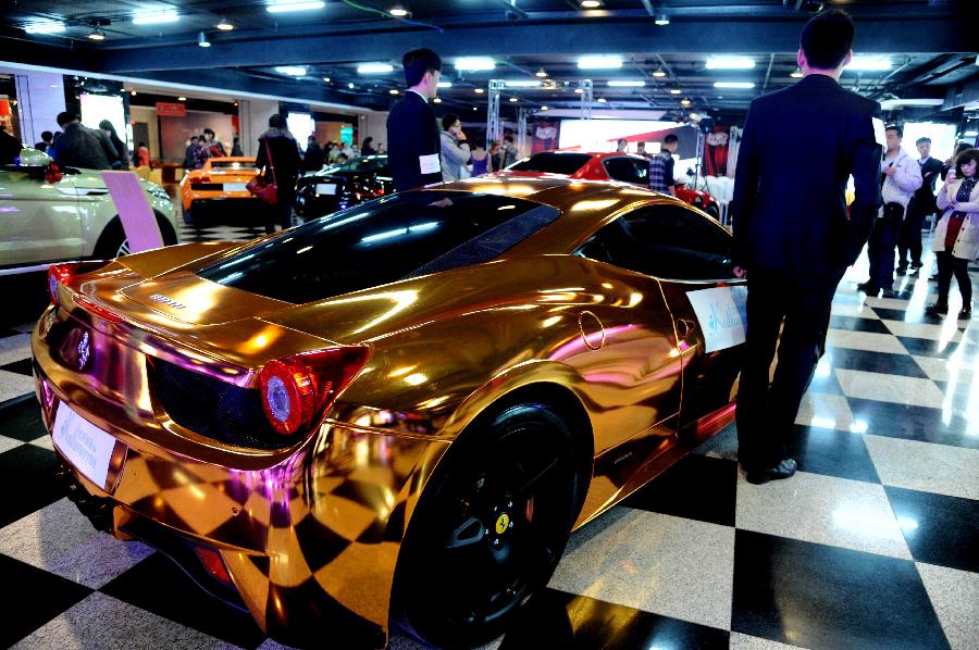Photo taken on Nov. 3, 2012 shows a gilded Ferrari wedding car displayed at the 6th Northeast Asia Autumn International Wedding Expo in Shenyang, capital of northeast China's Liaoning Province. (Xinhua) 