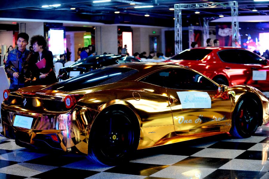 Photo taken on Nov. 3, 2012 shows a gilded Ferrari wedding car displayed at the 6th Northeast Asia Autumn International Wedding Expo in Shenyang, capital of northeast China's Liaoning Province. (Xinhua) 