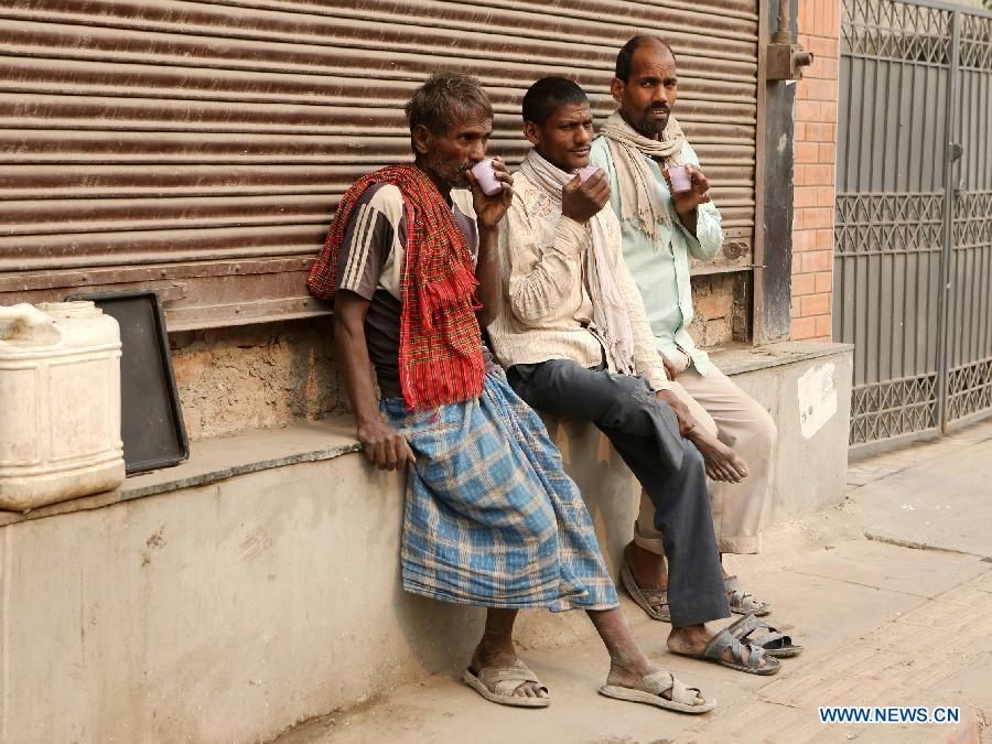 Rickshaw drivers drink tea in East Patel Nagar, northern New Delhi, India, on Nov. 5, 2012. Rickshaw drivers' life is hard in the old city of New Delhi. (Xinhua/Li Yigang) 