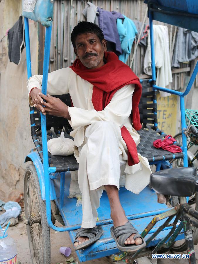 A rickshaw driver rests in East Patel Nagar, northern New Delhi, India, on Nov. 5, 2012. Rickshaw drivers' life is hard in the old city of New Delhi. (Xinhua/Li Yigang) 
