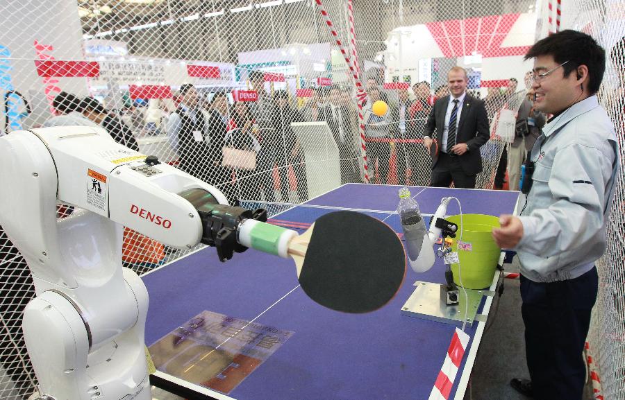An industrial robot serve a ping-pong ball at the 2012 China International Industry Fair in east China's Shanghai Municipality, Nov. 6, 2012. The five-day Fair, which kicked off on Tuesday, is held in November annually since 1999. (Xinhua/Pei Xin)