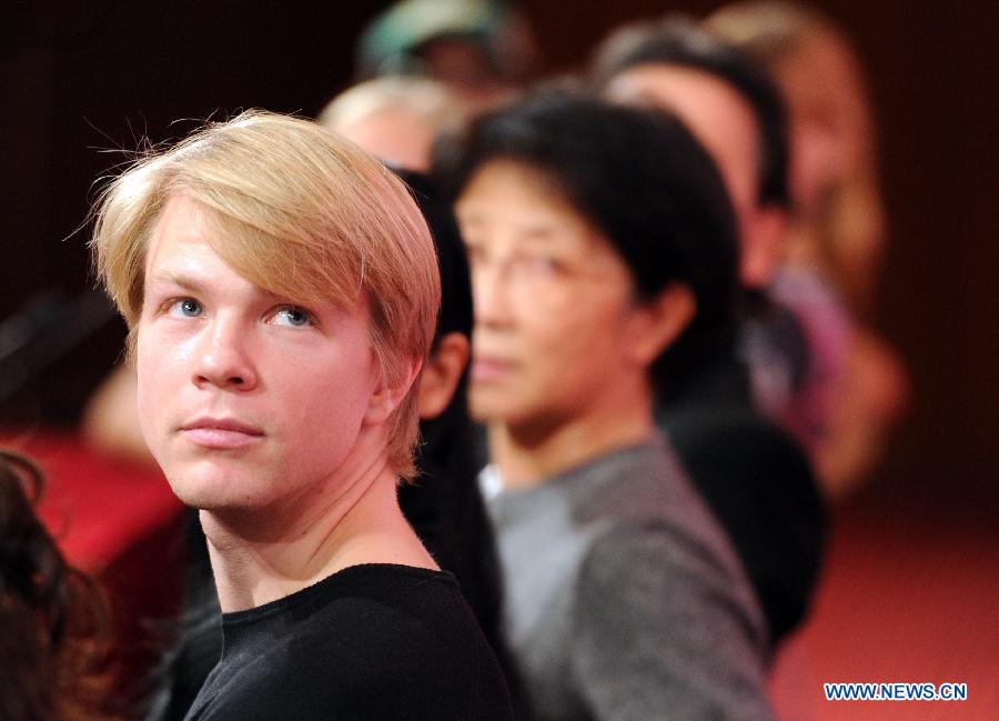 German actor Marijn Rademaker watches a video during a press conference of the stage drama "The Lady of The Camallias" in Beijing, capital of China, Nov. 6, 2012. (Xinhua/Luo Xiaoguang)