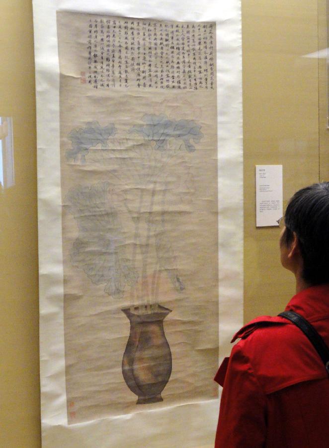 A visitor watches ancient Chinese calligraphy and painting works at Suzhou Museum in Suzhou of east China's Jiangsu Province, Nov. 6, 2012. (Xinhua/Chen Yu)