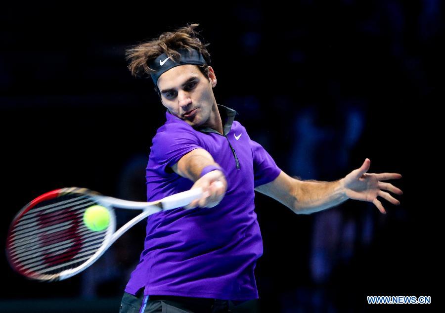 Roger Federer of Switzerland returns a shot during the men's singles Group B tennis match against Janko Tipsarevic of Serbia at the ATP World Tour Finals at the O2 Arena in London, Britain, on Nov. 6, 2012. Roger Federer won 2-0. (Xinhua/Tang Shi)