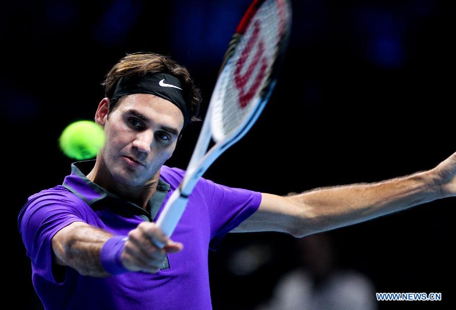 Roger Federer of Switzerland returns a shot during the men's singles Group B tennis match against Janko Tipsarevic of Serbia at the ATP World Tour Finals at the O2 Arena in London, Britain, on Nov. 6, 2012. Roger Federer won 2-0. (Xinhua/Tang Shi) 