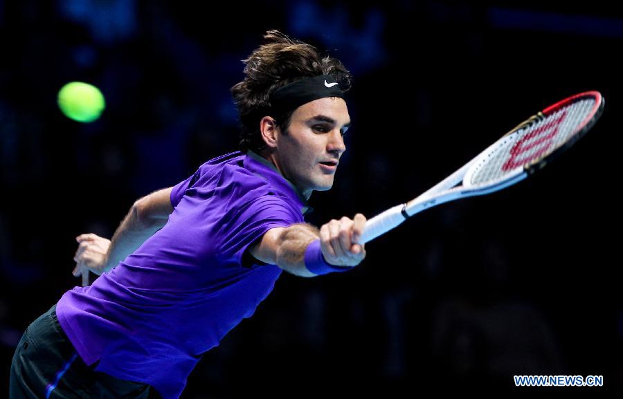 Roger Federer of Switzerland returns a shot during the men's singles Group B tennis match against Janko Tipsarevic of Serbia at the ATP World Tour Finals at the O2 Arena in London, Britain, on Nov. 6, 2012. Roger Federer won 2-0. (Xinhua/Tang Shi) 