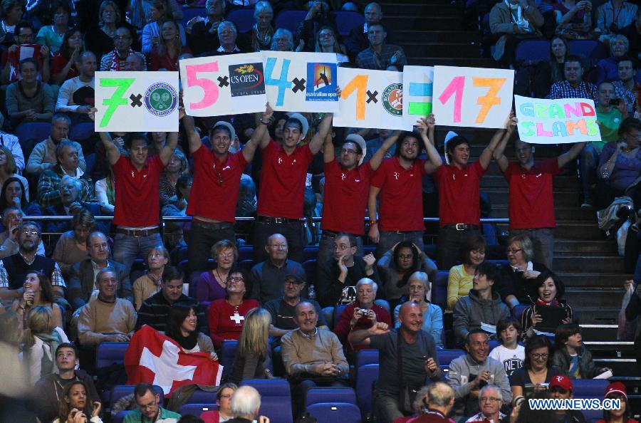 Fans hold banners for Roger Federer of Switzerland during his men's singles Group B tennis match against Janko Tipsarevic of Serbia at the ATP World Tour Finals at the O2 Arena in London, Britain, on Nov. 6, 2012. Roger Federer won 2-0. (Xinhua/Tang Shi) 