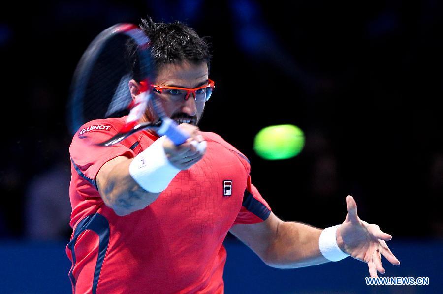 Janko Tipsarevic of Serbia returns a shot during the men's singles Group B tennis match against Roger Federer of Switzerland at the ATP World Tour Finals at the O2 Arena in London, Britain, on Nov. 6, 2012. Roger Federer won 2-0. (Xinhua/Tang Shi) 