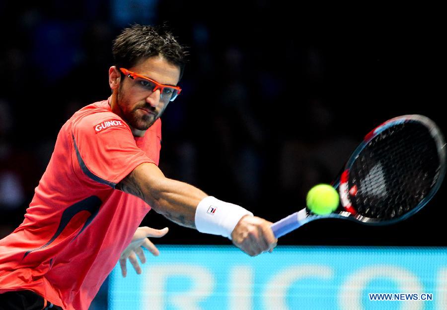 Janko Tipsarevic of Serbia returns a shot during the men's singles Group B tennis match against Roger Federer of Switzerland at the ATP World Tour Finals at the O2 Arena in London, Britain, on Nov. 6, 2012. Roger Federer won 2-0. (Xinhua/Tang Shi) 