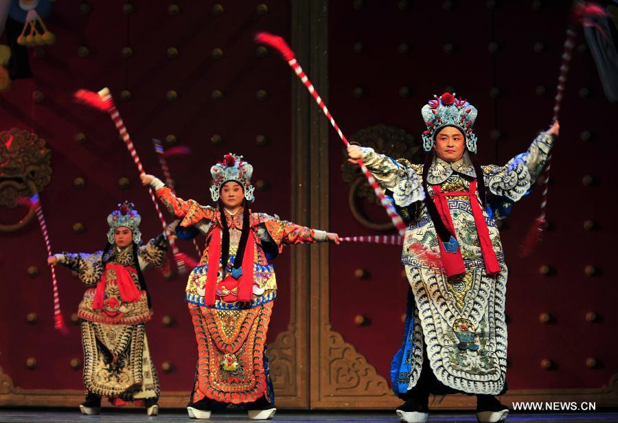 Actors perform on the stage of the Gansu Theater in Lanzhou, capital of northwest China's Gansu Province, Nov. 6, 2012. A performance was held here Tuesday night to celebrate the opening of an eight-day Shaanxi opera art festival. Shaanxi Opera, commonly known as Qinqiang, is the oldest of all the Chinese operas that are still in existence today. (Xinhua/Liang Qiang) 