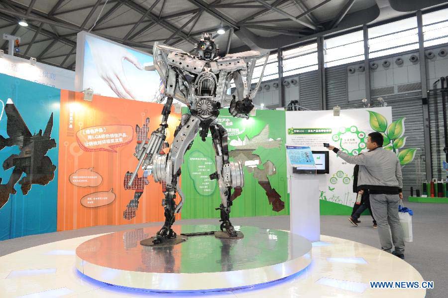 Visitors watch a robot on the 2012 China International Industry Fair in east China's Shanghai Municipality, Nov. 6, 2012. The industry fair, with the participation of 63 colleges displaying a lot of scientific projects including 51 major technological achievement projects, was open to the public on Tuesday. (Xinhua/Lai Xinlin)