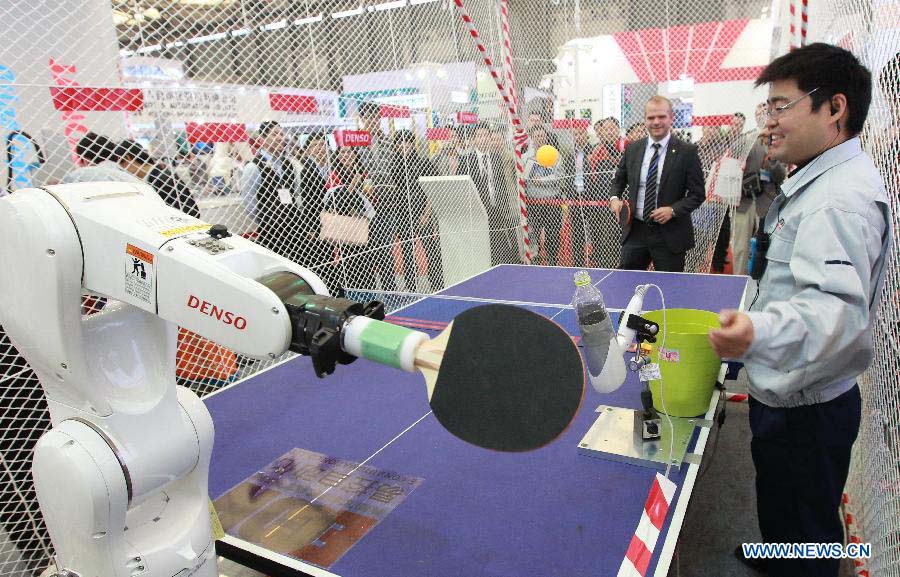 An industrial robot serve a ping-pong ball at the 2012 China International Industry Fair in east China's Shanghai Municipality, Nov. 6, 2012. The five-day Fair, which kicked off on Tuesday, is held in November annually since 1999. (Xinhua/Pei Xin) 