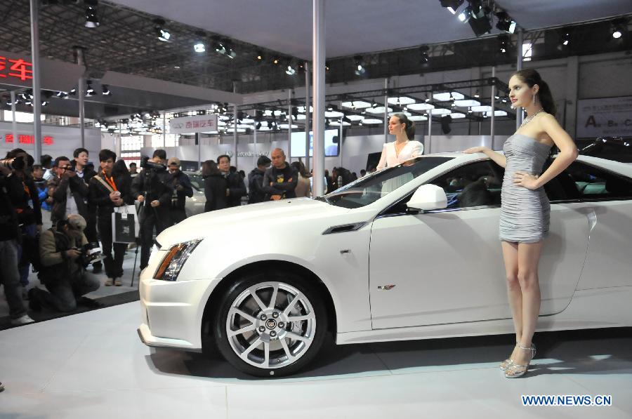 Models present a Cadillac vehicle at the 13th International Automobile Industry Exhibition in Hangzhou, capital of east China's Zhejiang Province, Nov. 7, 2012. The five-day exhibition, which kicked off on Wednesday, displays vehicles of 60 brands from both home and abroad. (Xinhua/Zhu Yinwei)