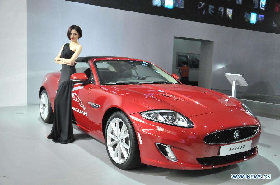 A model presents a Jaguar XKR coupe at the 13th International Automobile Industry Exhibition in Hangzhou, capital of east China's Zhejiang Province, Nov. 7, 2012. The five-day exhibition, which kicked off on Wednesday, displays vehicles of 60 brands from both home and abroad. (Xinhua/Zhu Yinwei)