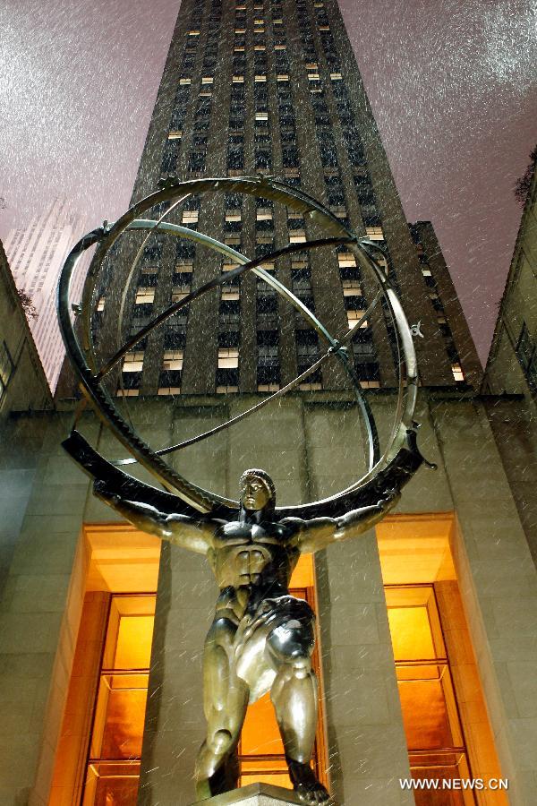 The Statue of Atlas is seen in snow at Rockefeller Center in New York, the United States, Nov. 7, 2012. As New Jersey and New York are still trying to recover from the damage created by Hurricane Sandy, a Nor'easter named Winter Storm Athena dropped snow and rain on the Northeast on Wednesday, also bringing dangerous winds and knocking out power. (Xinhua/Wu Jingdan)