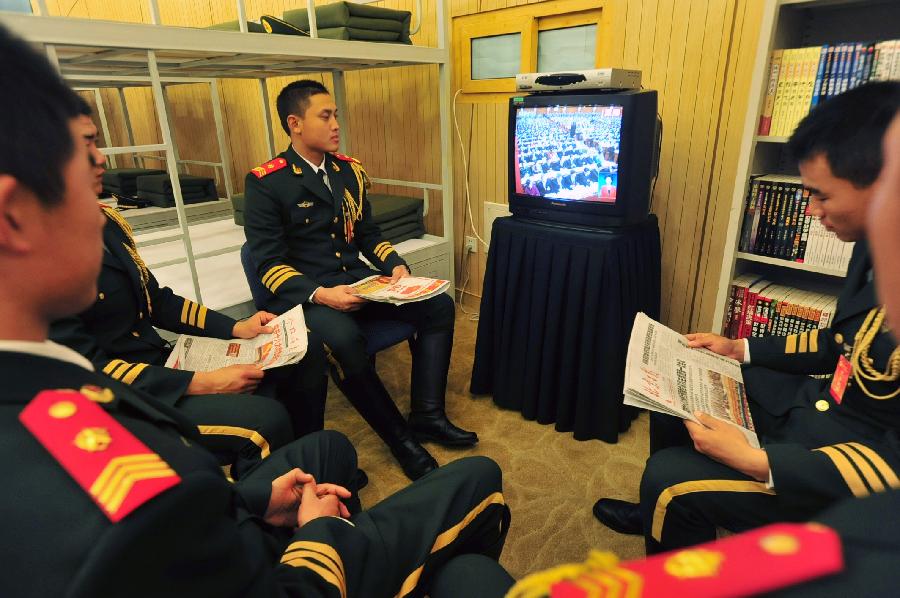 Soldiers of armed police watch live TV report on the opening ceremony of the 18th National Congress of the Communist Party of China (CPC) in Beijing, capital of China, Nov. 8, 2012. The 18th CPC National Congress was opened in Beijing on Thursday. (Xinhua/Liu Changlong)