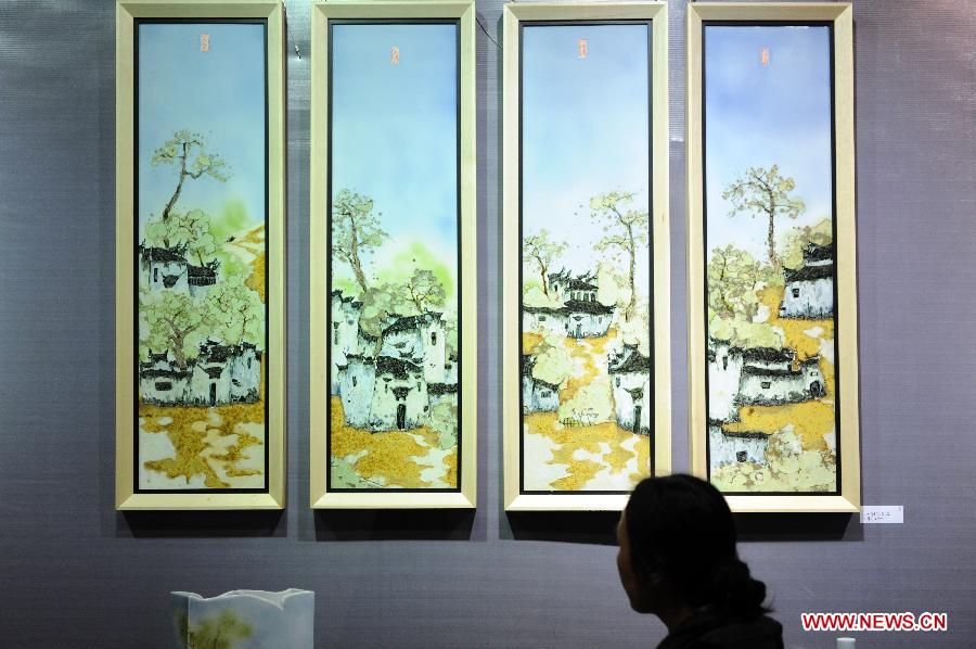 A woman visits the 15th West Lake Art Fair in Hangzhou, capital of east China's Zhejiang Province, Nov. 8, 2012. The five-day fair, which kicked off on Thursday, attracted more than 200 exhibitors. (Xinhua/Ju Huanzong)