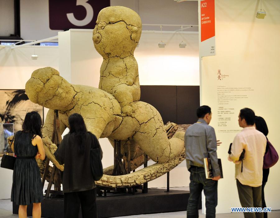 A visitor looks at an art work displayed at the exhibiton "Art Taipei 2012" in Taipei, southeast China's Taiwan, Nov. 8, 2102. "Art Taipei 2012" will take place from Nov. 9 to 12 at Taipei World Trade Center, displaying more than 2,000 art works from 150 galleries of 15 countries and regions. (Xinhua/Wu Ching-teng)