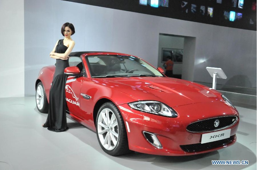 A model presents a Jaguar XKR coupe at the 13th International Automobile Industry Exhibition in Hangzhou, capital of east China's Zhejiang Province, Nov. 7, 2012. The five-day exhibition, which kicked off on Wednesday, displays vehicles of 60 brands from both home and abroad. (Xinhua/Zhu Yinwei) 
