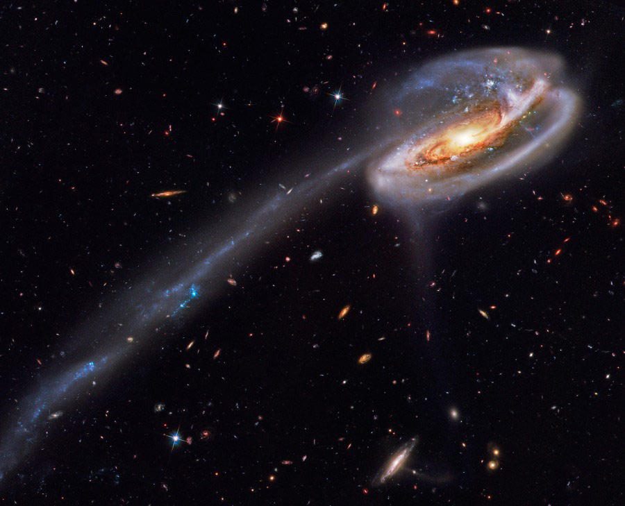 Arp 188 and the Tadpole's Tail. In this stunning vista, based on image data from the Hubble Legacy Archive, distant galaxies form a dramatic backdrop for disrupted spiral galaxy Arp 188, the Tadpole Galaxy. The cosmic tadpole is a mere 420 million light-years distant toward the northern constellation Draco. (Photo/ NASA)