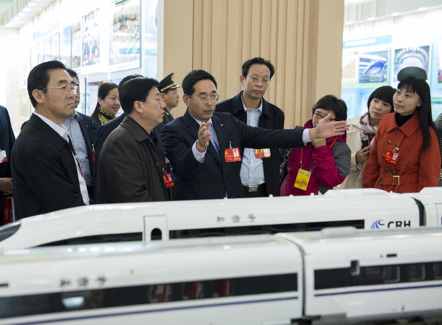 Delegates to the 18th National Congress of the Communist Party of China (CPC) visit a photo exhibition on achievements which China has gained under the leadership of the CPC, at Beijing Exhibition Center in Beijing, capital of China, Nov. 9, 2012. (Xinhua/Wang Ye)