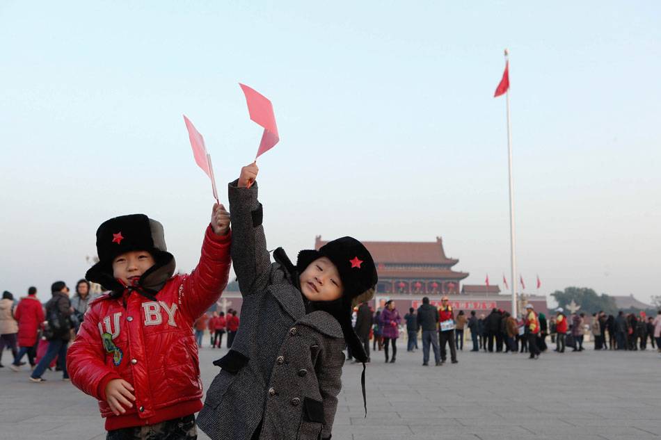 Liu Zetao, six-year-old, and Liu Mingxi, five-year-old take photos together at the Tian'anmen Square Beijing, Nov. 7, 2012. (Xinhua/Jin Liwang)