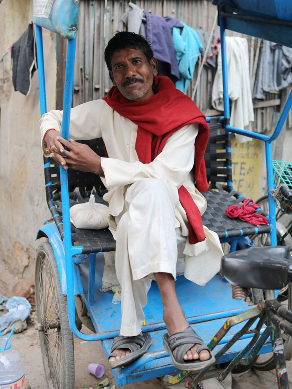 A rickshaw driver rests in East Patel Nagar, northern New Delhi, India, on Nov. 5, 2012. Rickshaw drivers' life is hard in the old city of New Delhi. (Xinhua/Li Yigang)