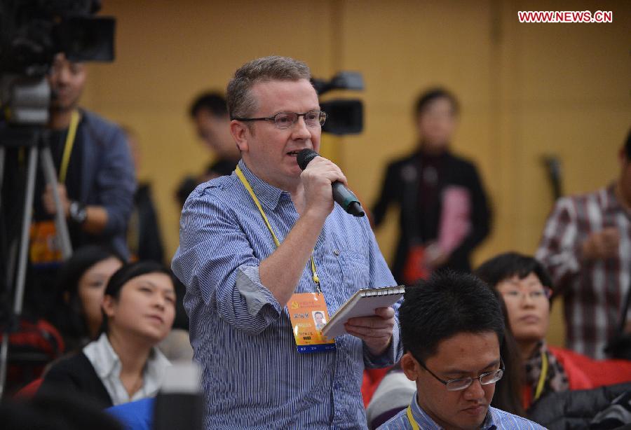 A journalist with the Wall Street Journal asks questions during a group interview, with its theme "implement innovation strategies to accelerate transformation and development", which is held by the press center of the 18th National Congress of the Communist Party of China (CPC) in Beijing, capital of China, Nov. 10, 2012.(Xinhua/Li Xin) 