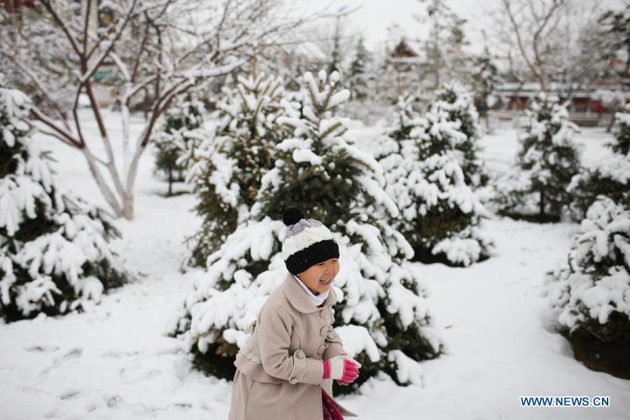 A child plays in a snow-covered field in Hohhot, capital of north China's Inner Mongolia Autonomous Region, Nov. 10, 2012. A heavy snowfall hit Hohhot on Nov. 9. (Xinhua/Zhang Fan)