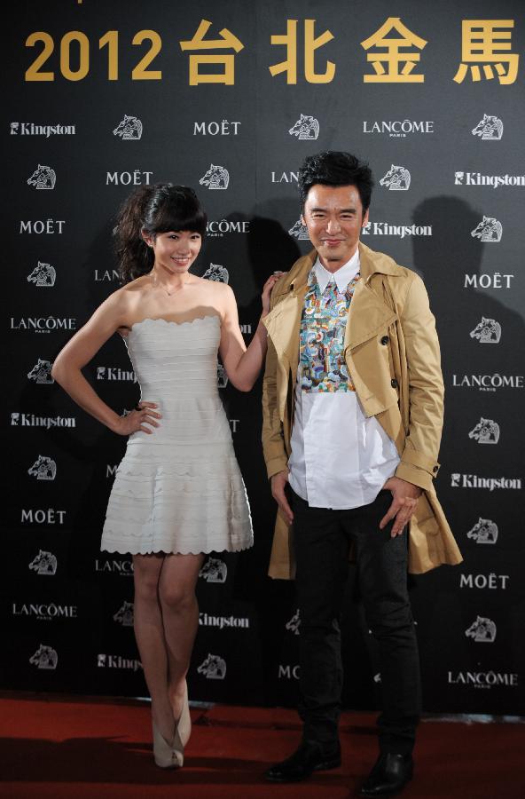 Chung Jan To (R) and Li Chien-na, who starred in the film "Together", attend the opening ceremony of the Taipei Golden Horse Film Festival in Taipei, southeast China's Taiwan, Nov. 9, 2012. "Together" is the opening film of the Taipei Golden Horse Film Festival, which kicked off Friday in Taipei. (Xinhua/Yin Bogu)
