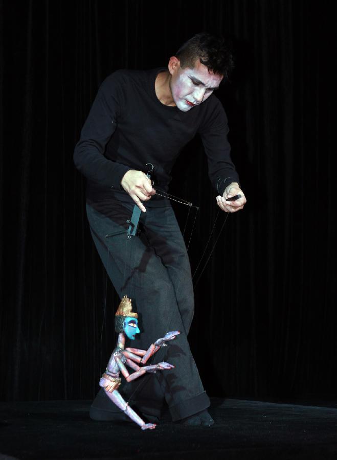 A puppeteer gives performance during the third Shanghai International Puppet Festival in east China's Shanghai, Nov. 9, 2012. The puppet festival, which opened here on Friday, is part of the 14th Shanghai International Arts Festival. The event attracted 11 foreign puppet theatres. (Xinhua/Ding Ting)