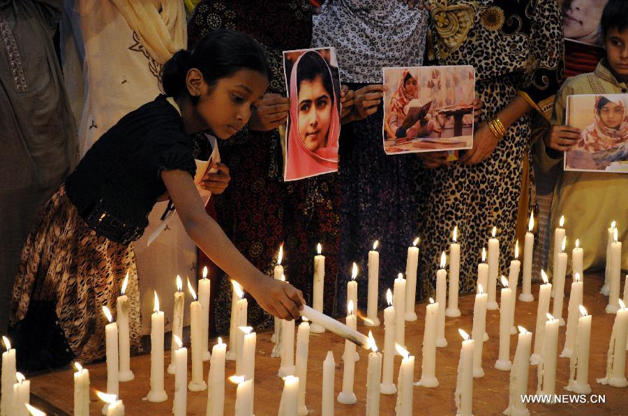 A Pakistani girl lights candles to mark the "Malala Day" in Karachi, Pakistan, Nov. 10, 2012. (Xinhua/Masroor)